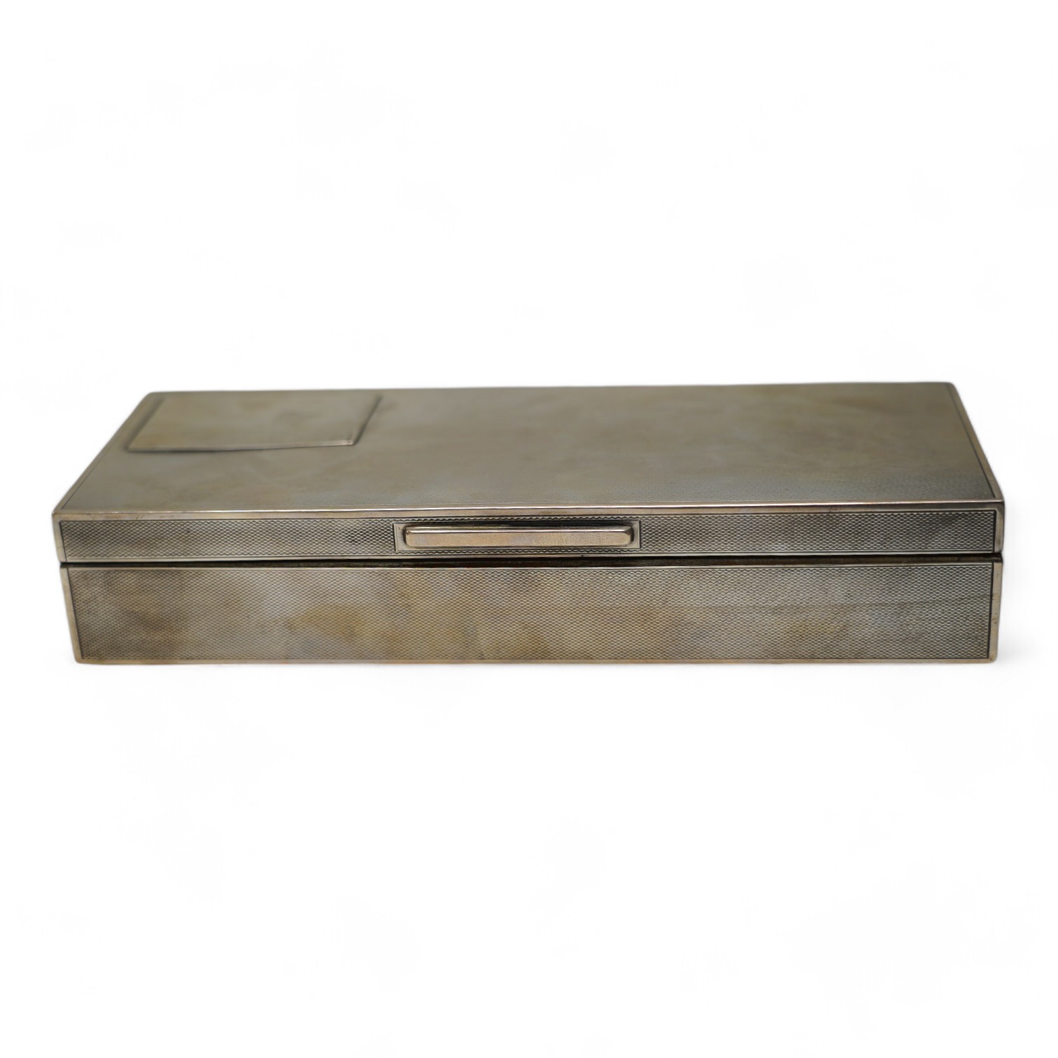 A George V engine turned silver mounted rectangular cigarette box, London, 1935, 21.7cm. Condition - poor